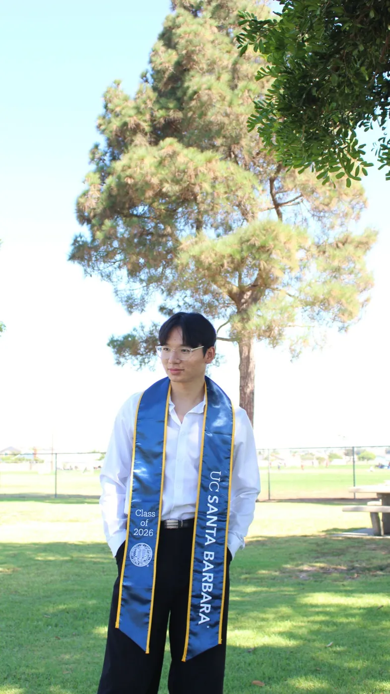 Francis wearing a graduation stole