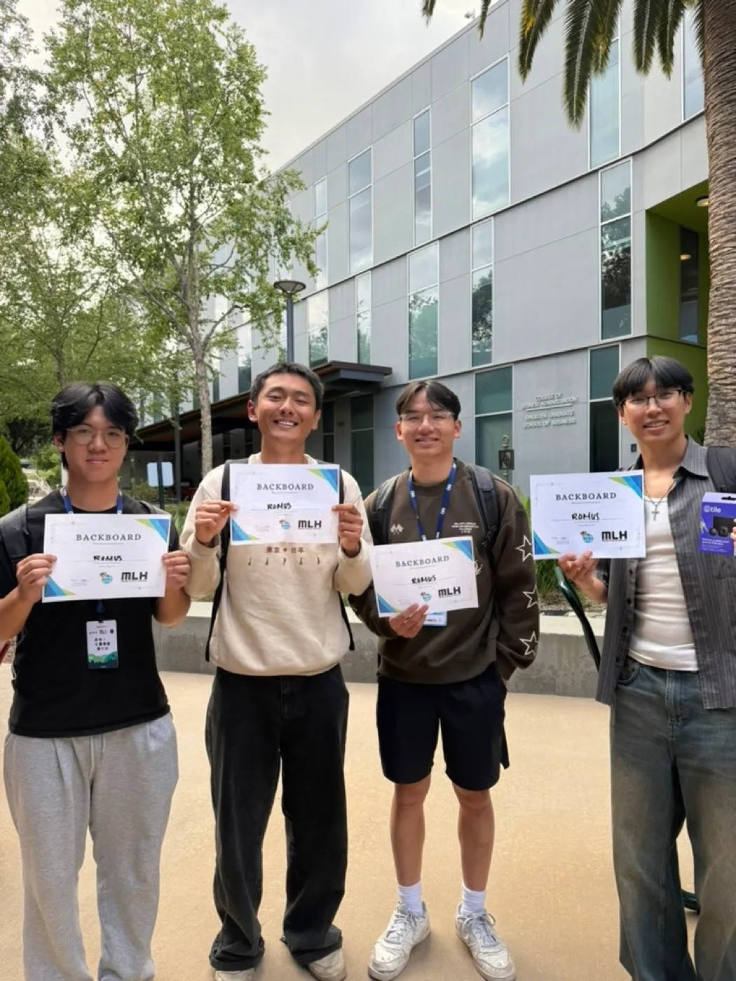 Francis and his hackathon team holding certificates